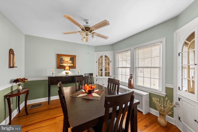 dining area featuring ceiling fan and light hardwood / wood-style flooring