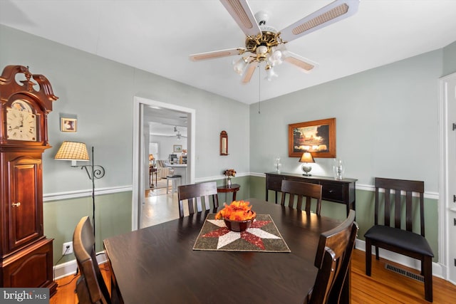 dining space featuring light wood-type flooring and ceiling fan