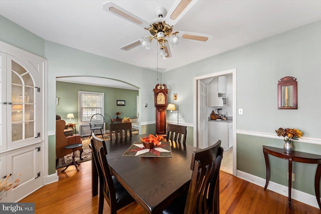 dining space with hardwood / wood-style floors and ceiling fan