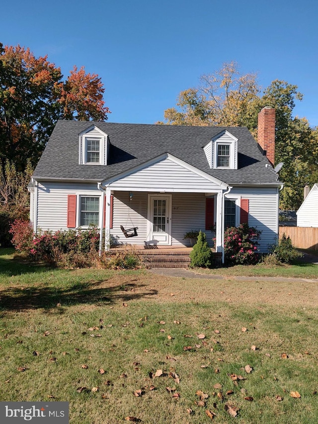 cape cod house featuring a front lawn and covered porch