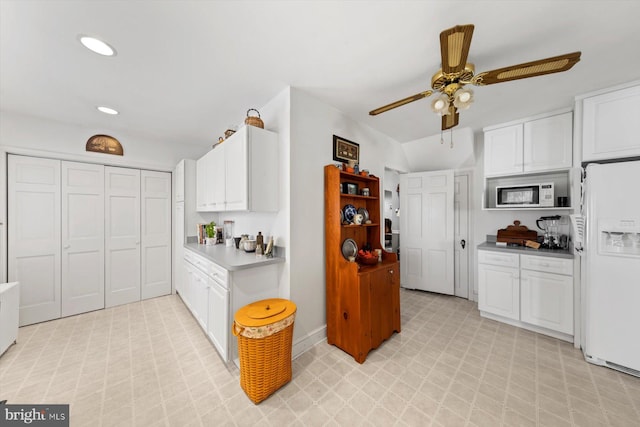 kitchen with white cabinetry, lofted ceiling, ceiling fan, and white appliances