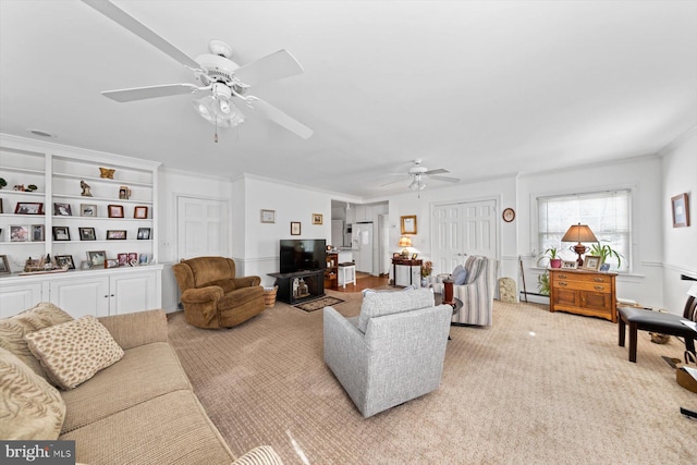 living room with ceiling fan, a baseboard radiator, and crown molding