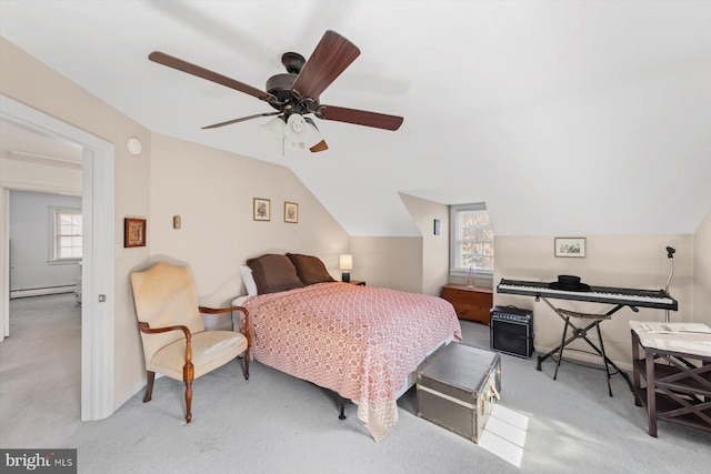 bedroom featuring lofted ceiling, multiple windows, ceiling fan, and a baseboard radiator