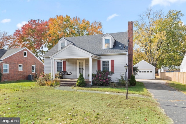 cape cod-style house featuring an outbuilding, a garage, a front lawn, central AC, and covered porch