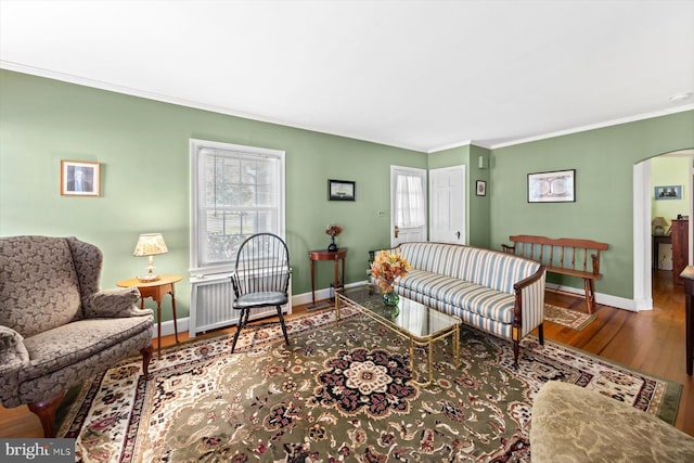 living room with hardwood / wood-style flooring and crown molding