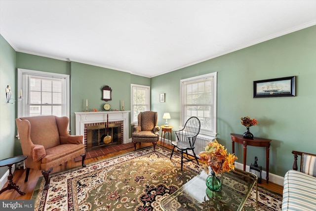 living room featuring a fireplace, hardwood / wood-style flooring, plenty of natural light, and crown molding