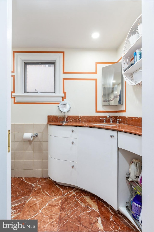 bathroom featuring tile walls and vanity