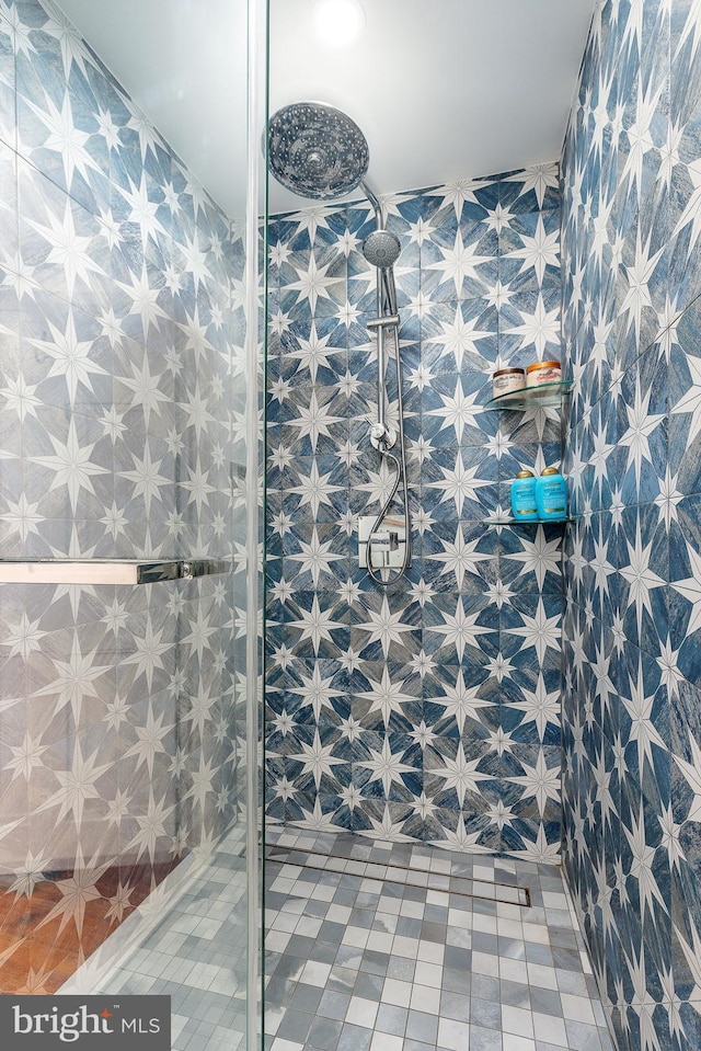 bathroom with a shower and tile walls