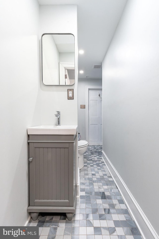 bathroom featuring vanity and toilet