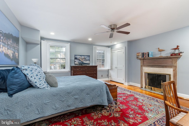 bedroom with ceiling fan and wood-type flooring