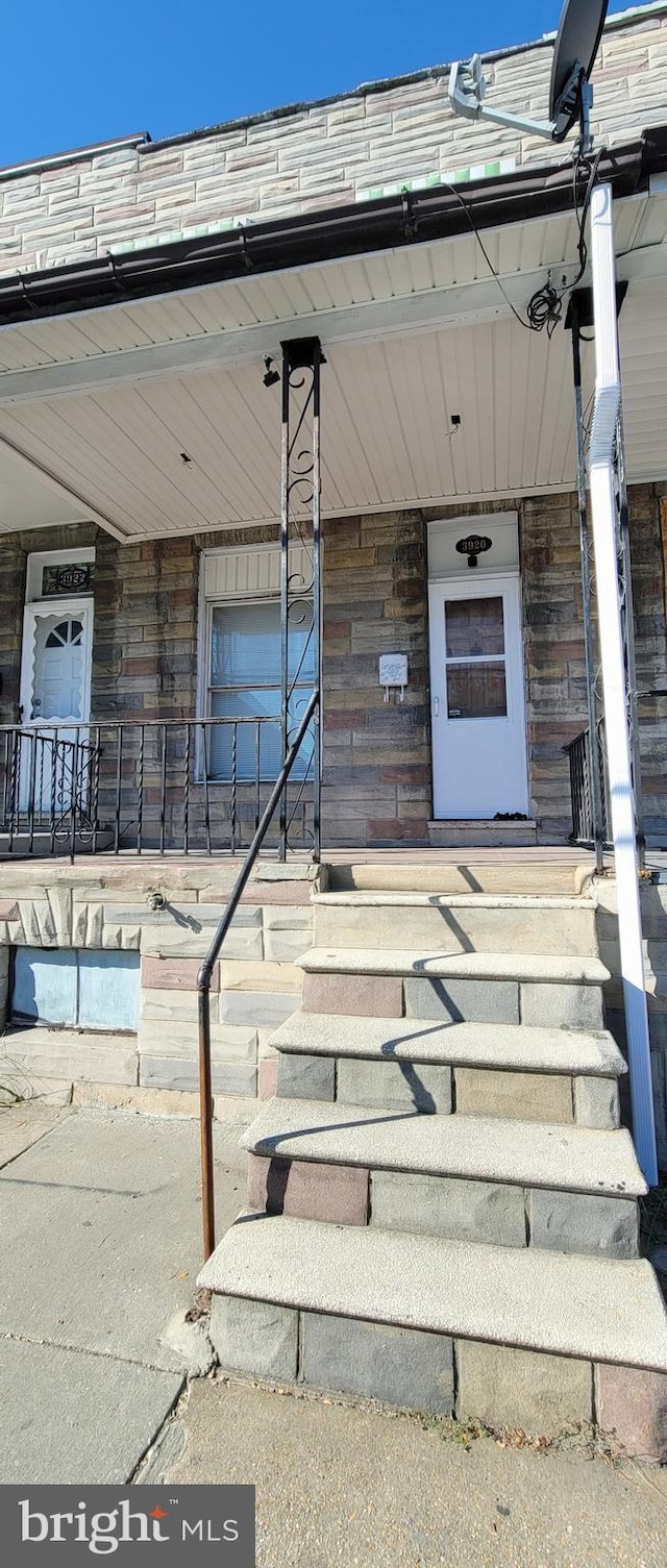 view of exterior entry with a porch