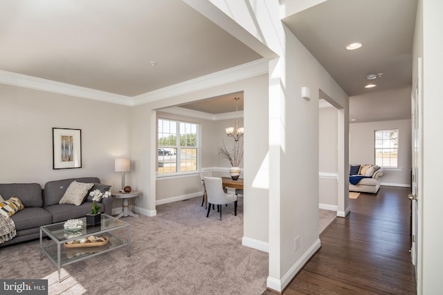 living room featuring crown molding, a notable chandelier, and dark wood-type flooring