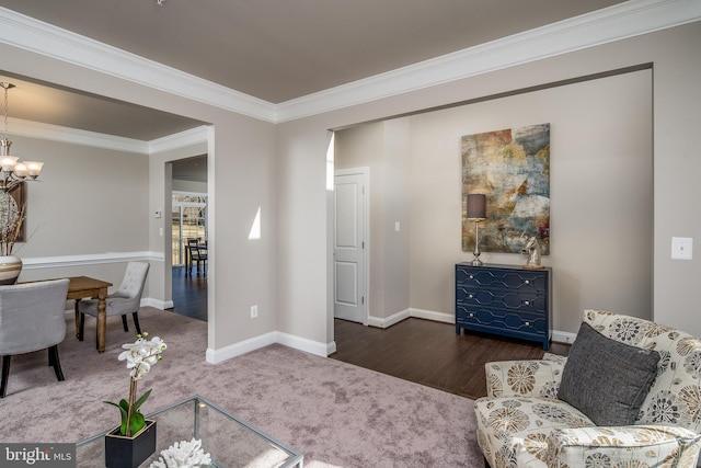 sitting room featuring crown molding, a notable chandelier, and dark hardwood / wood-style flooring