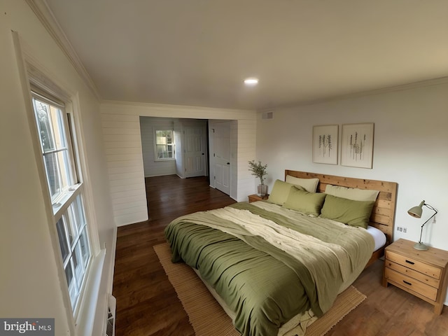 bedroom with recessed lighting, ornamental molding, visible vents, and wood finished floors