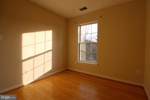 spare room featuring hardwood / wood-style floors