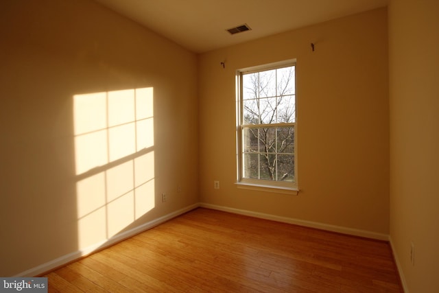 unfurnished room featuring hardwood / wood-style floors