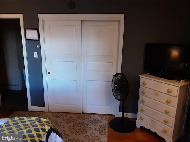 bedroom featuring hardwood / wood-style floors and a closet