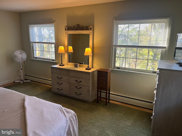 carpeted bedroom with multiple windows and a baseboard radiator