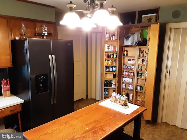 kitchen with an inviting chandelier and stainless steel fridge