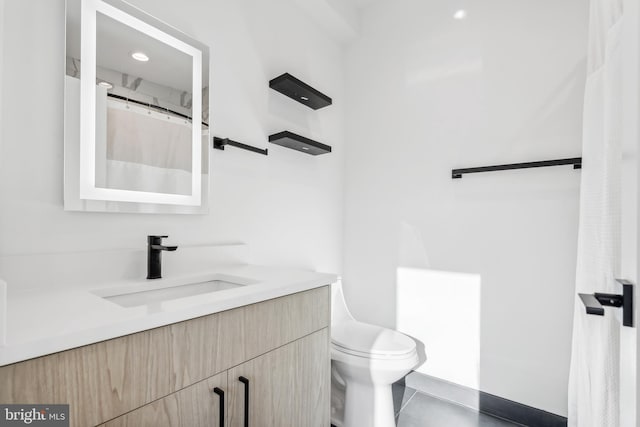 bathroom featuring vanity, toilet, and tile patterned flooring