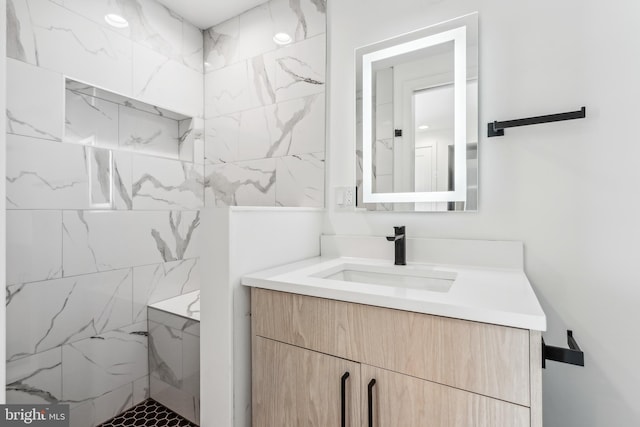 bathroom with vanity and tiled shower