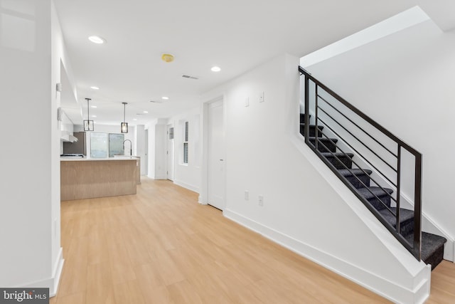 interior space with sink and light wood-type flooring