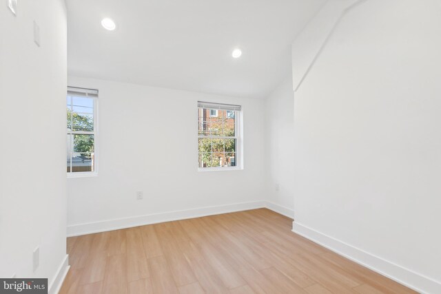 empty room with light hardwood / wood-style flooring