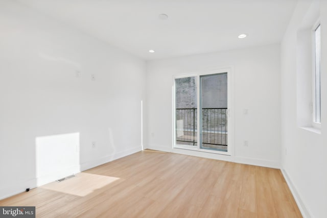 spare room featuring light hardwood / wood-style floors