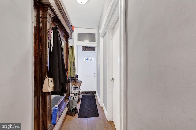 hallway with hardwood / wood-style flooring