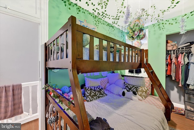 bedroom with a closet and hardwood / wood-style flooring