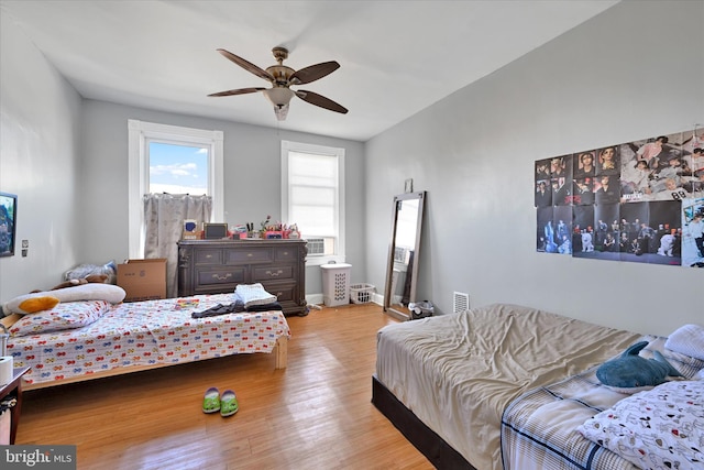 bedroom featuring light wood-type flooring and ceiling fan