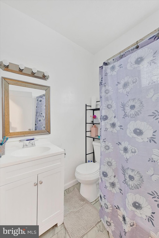 bathroom featuring vanity and toilet