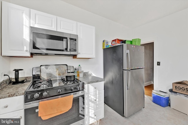 kitchen featuring white cabinetry and appliances with stainless steel finishes