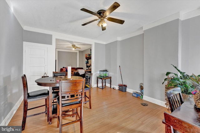 dining space with light hardwood / wood-style flooring, crown molding, and ceiling fan