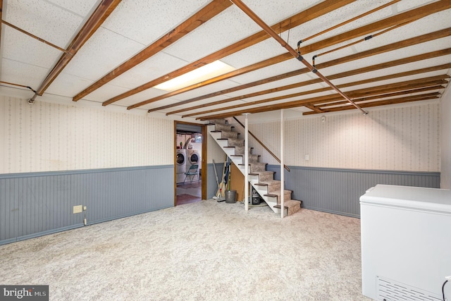 basement featuring carpet floors and fridge