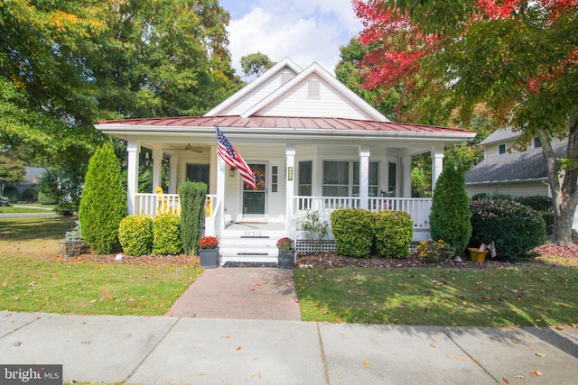 view of front of property with covered porch and a front yard