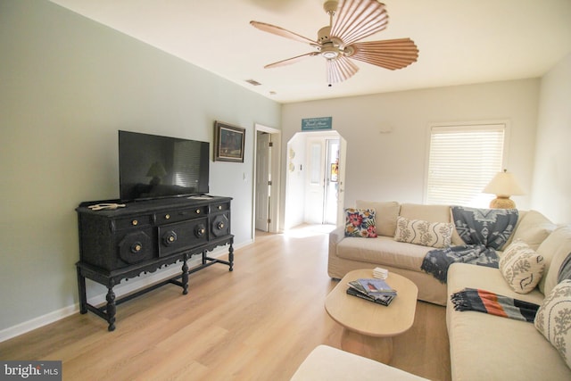 living room with light hardwood / wood-style flooring and ceiling fan