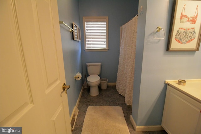 bathroom featuring vanity, a shower with shower curtain, and toilet