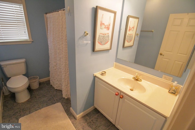 bathroom with vanity, toilet, and curtained shower