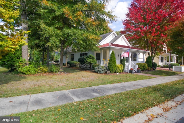 view of front of property featuring covered porch and a front lawn