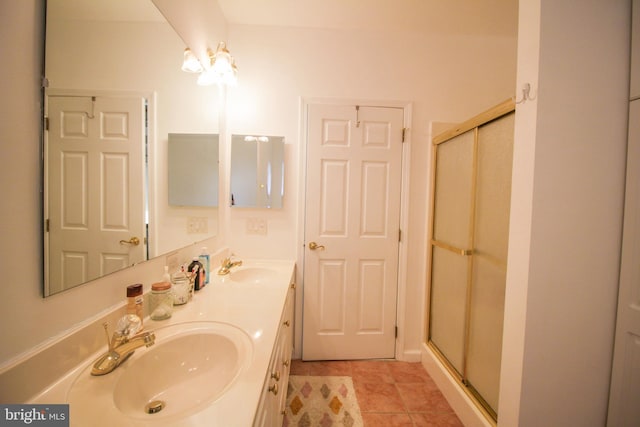 bathroom with vanity, an enclosed shower, and tile patterned floors