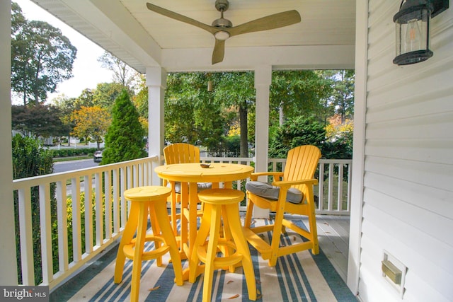 wooden terrace with covered porch and ceiling fan