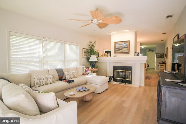 living room with light hardwood / wood-style floors and ceiling fan