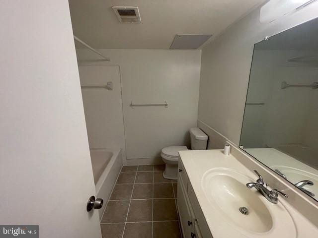 bathroom featuring tile patterned flooring, vanity, and toilet