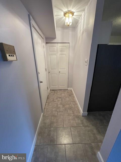 hallway featuring tile patterned flooring