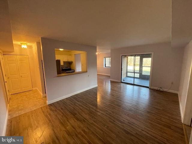 unfurnished living room with hardwood / wood-style flooring