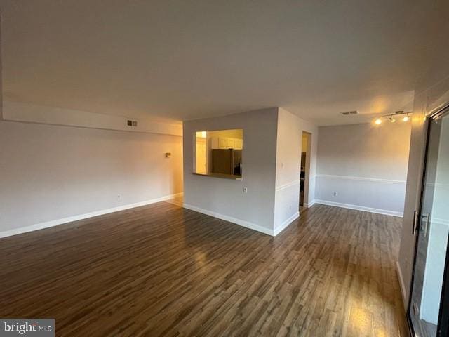 unfurnished living room featuring dark wood-type flooring