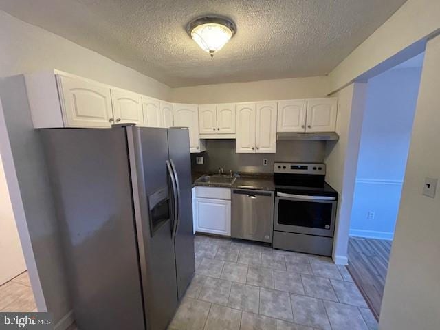 kitchen featuring white cabinetry, appliances with stainless steel finishes, sink, and a textured ceiling