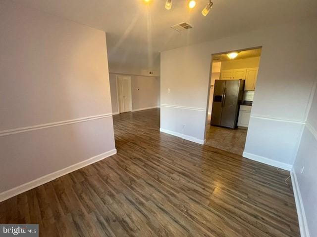 unfurnished room with dark wood-type flooring