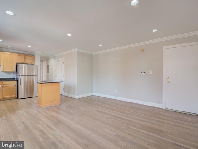 kitchen featuring a center island, light brown cabinetry, stainless steel refrigerator, light hardwood / wood-style flooring, and crown molding